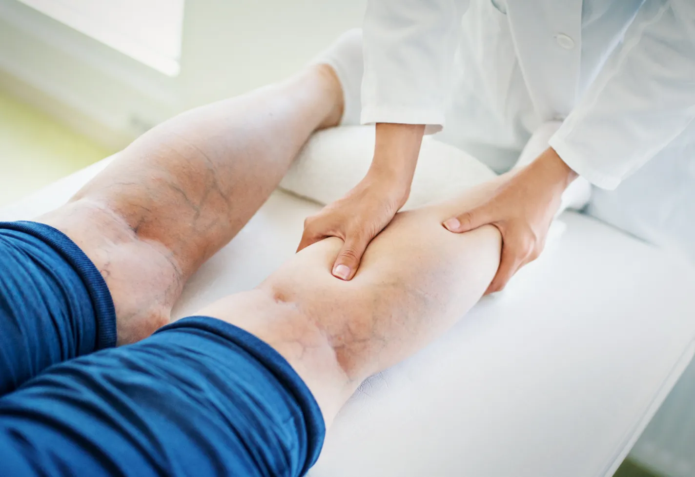 Clinical leg exam of a patients leg by a provider