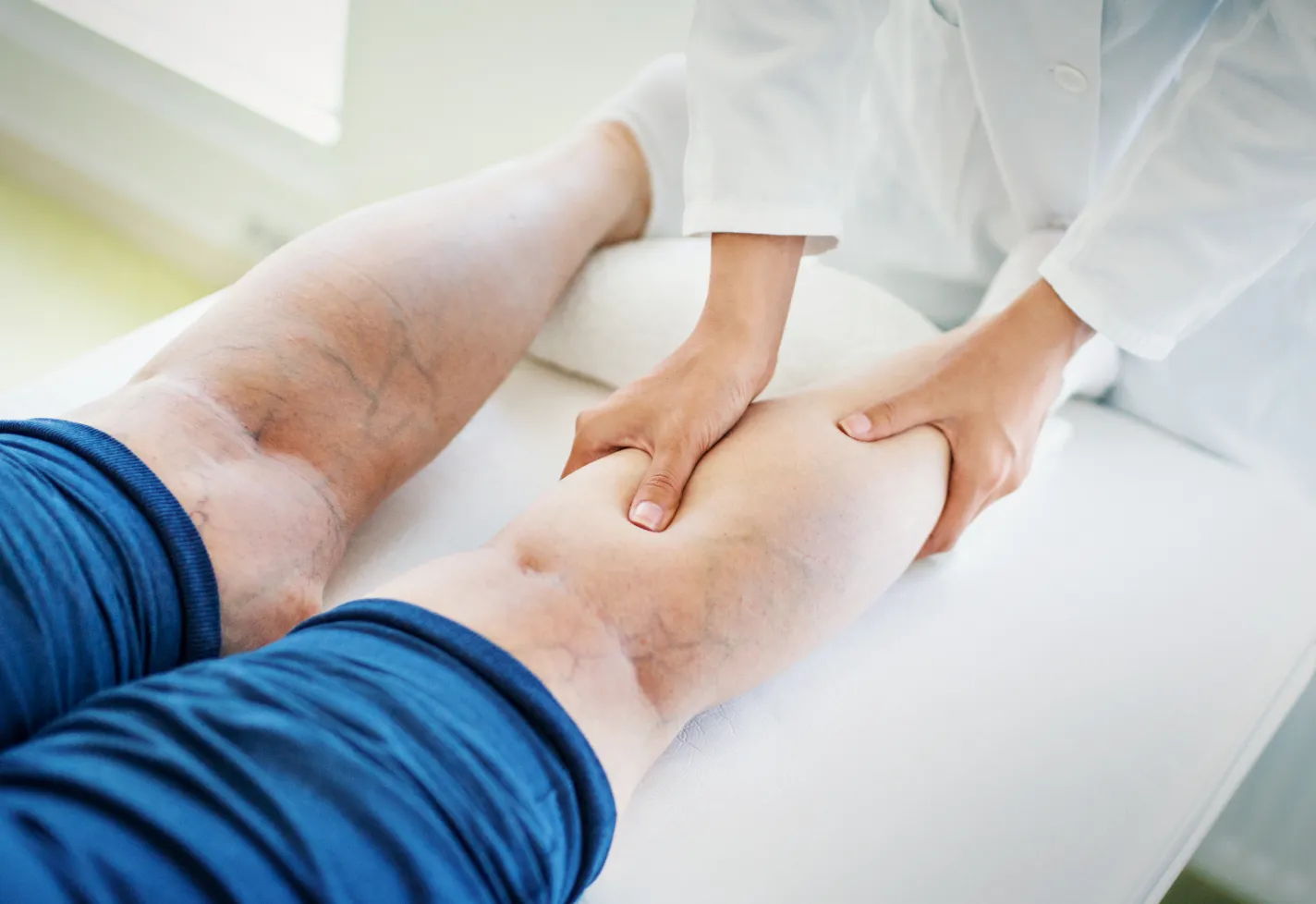Clinical leg exam of a patients leg by a provider Clinical leg exam of a patients leg by a provider