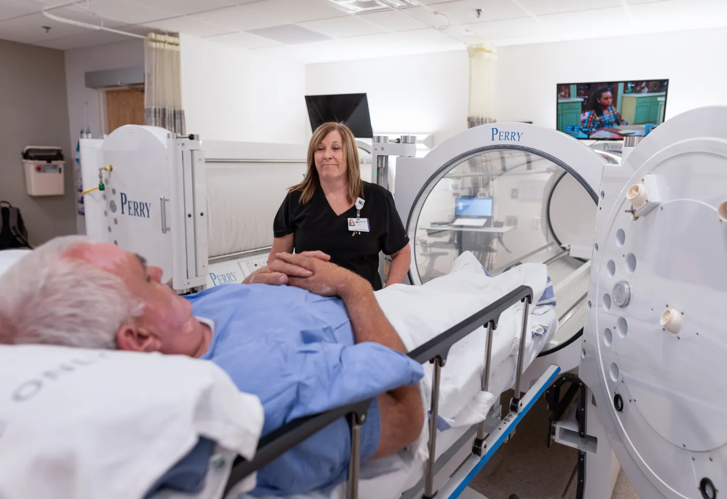 A nurse is talking with and preparing a patient for wound care treatment. A nurse is talking with and preparing a patient for wound care treatment.