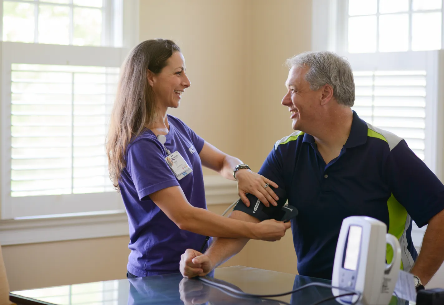 Physical therapy nurse checks a man's blood pressure