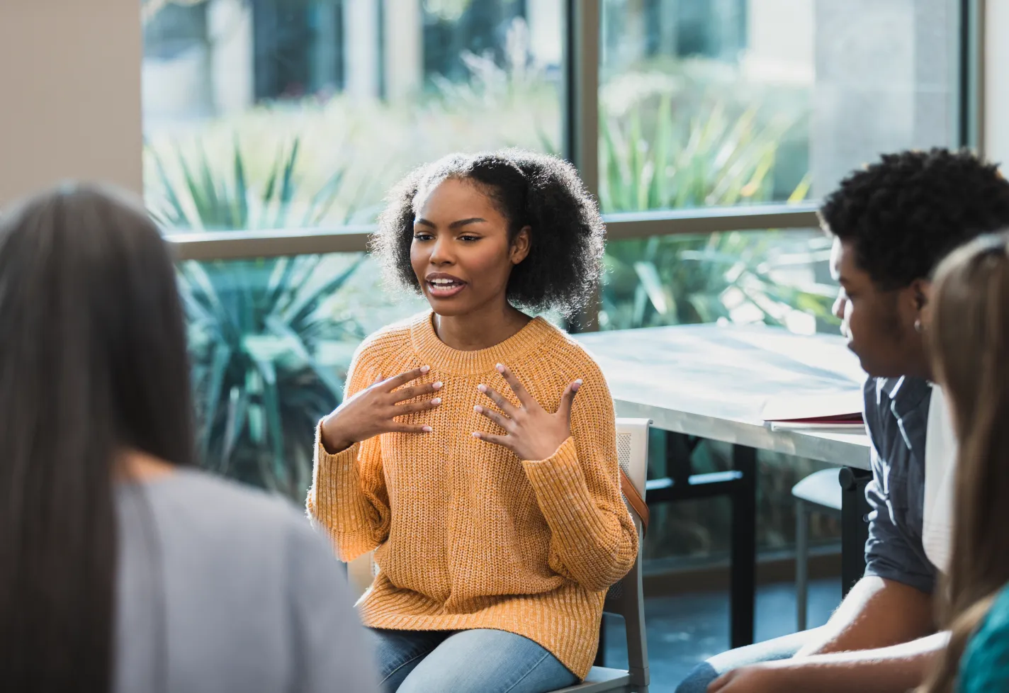 Woman speaking in a mental health support group Woman speaking in a mental health support group