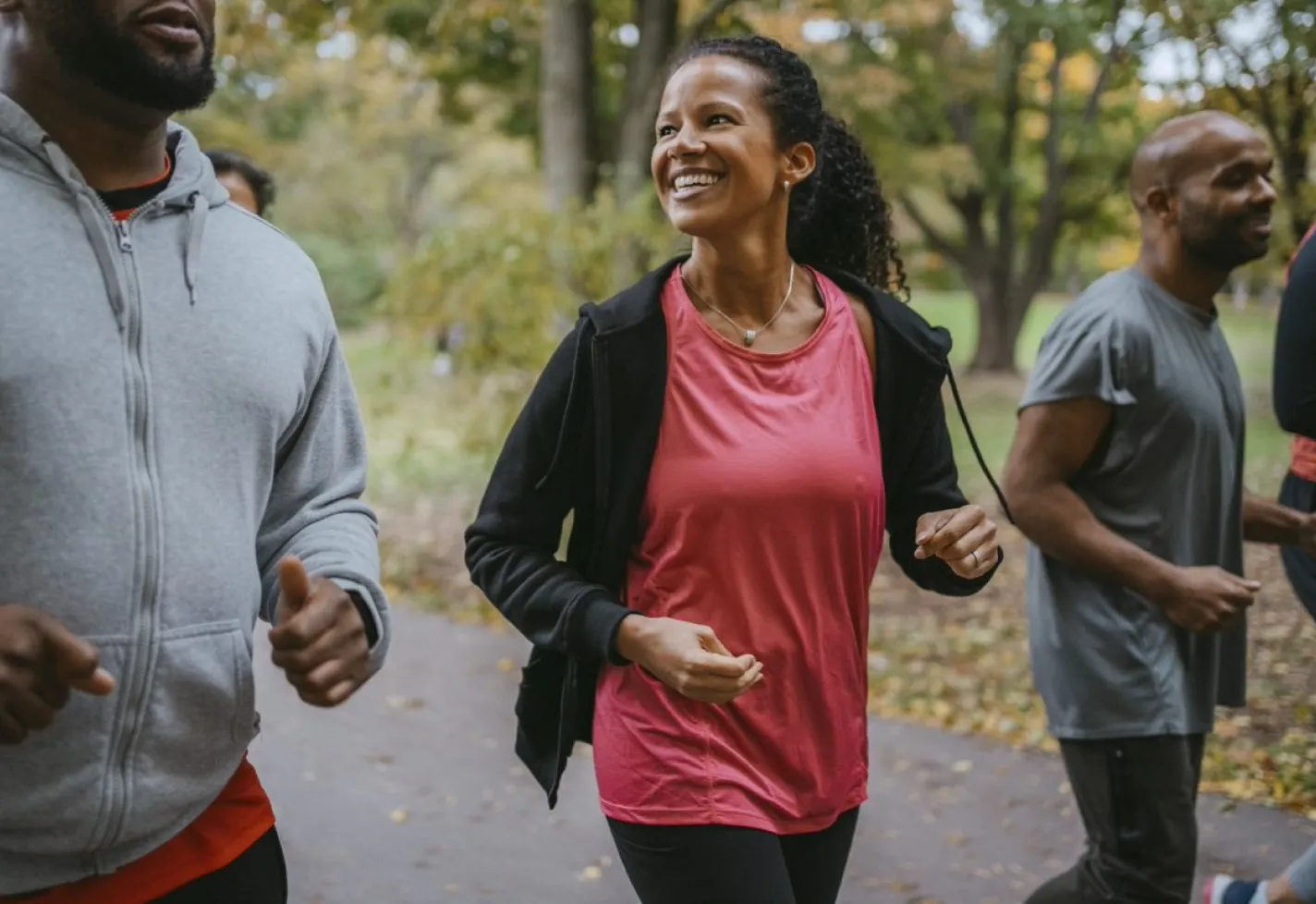 Group of people walking an outdoor trail together. 