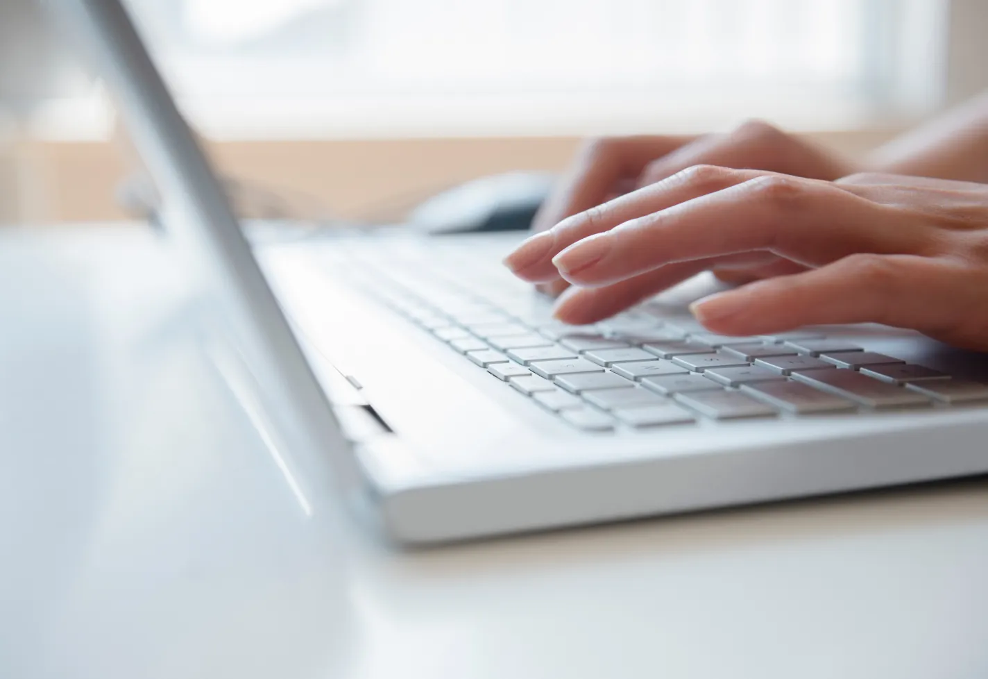 close-up of hands typing on a computer close-up of hands typing on a computer