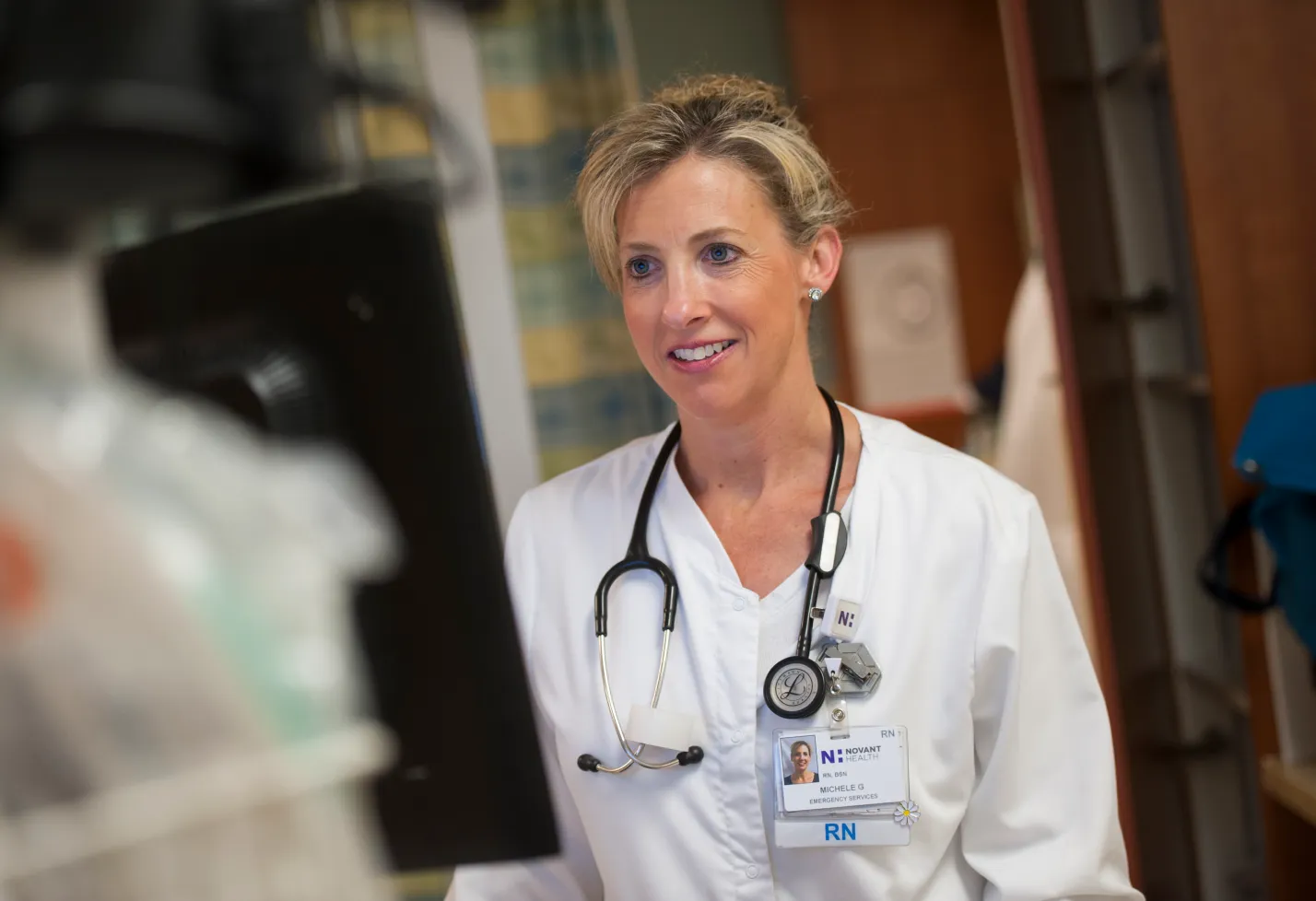 A Novant Health registered nurse (RN) is at a computer charting patient information. A Novant Health registered nurse (RN) is at a computer charting patient information.