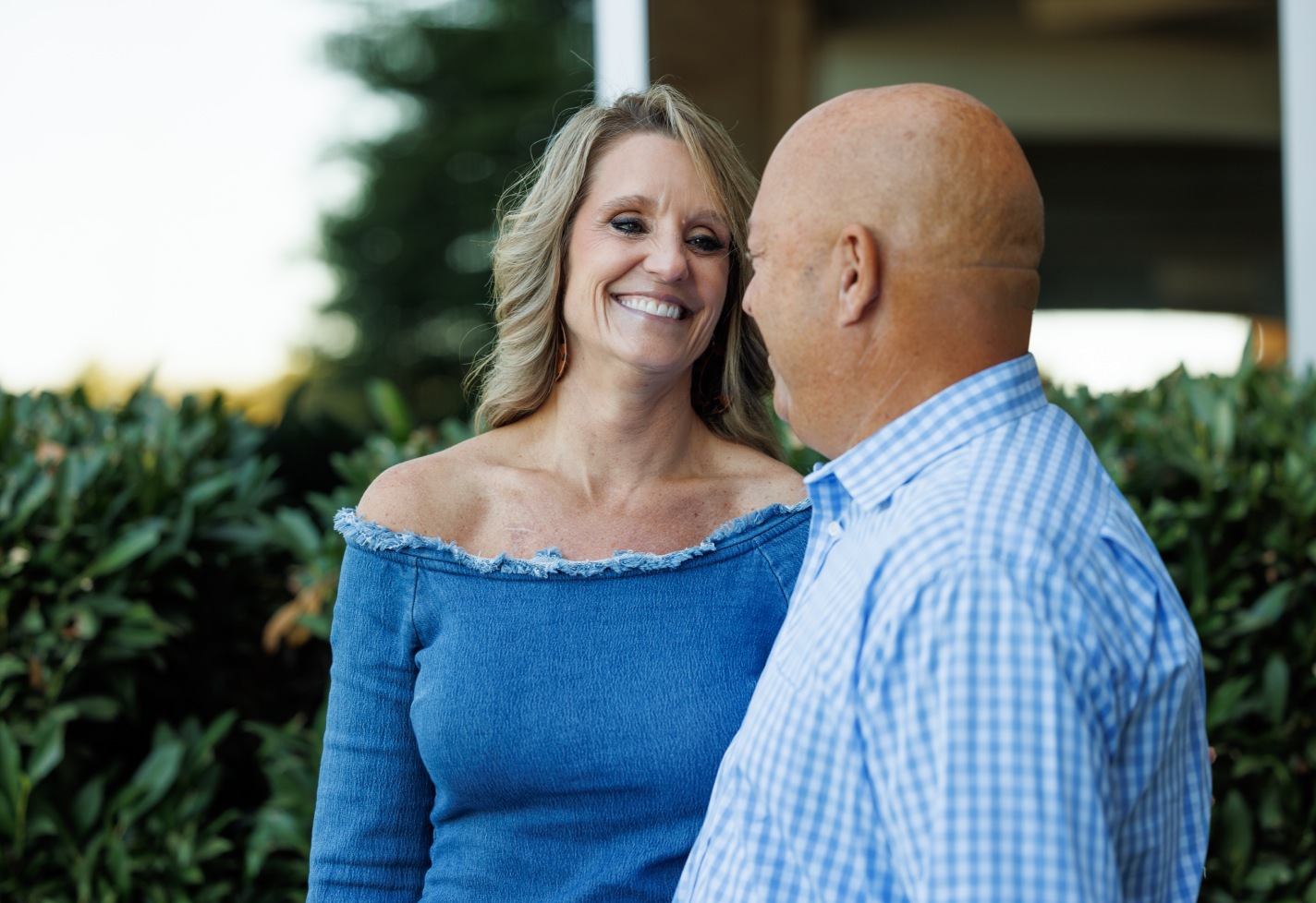 Traci George and her husband smiling Traci George and her husband smiling