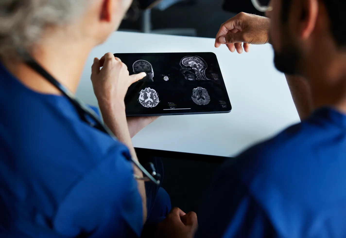 2 medical imaging specialists review a brain scan together