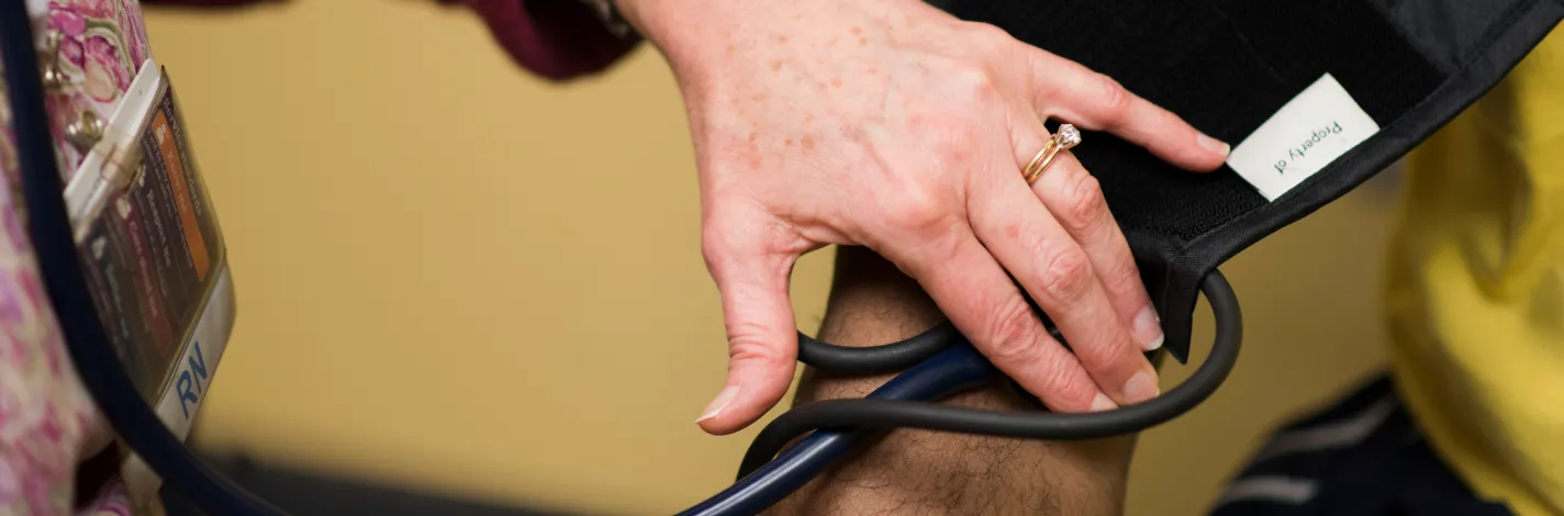 Provider taking a patient's blood pressure