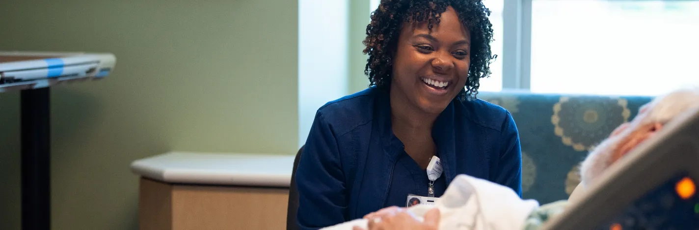 nurse with surgery patient in hospital room