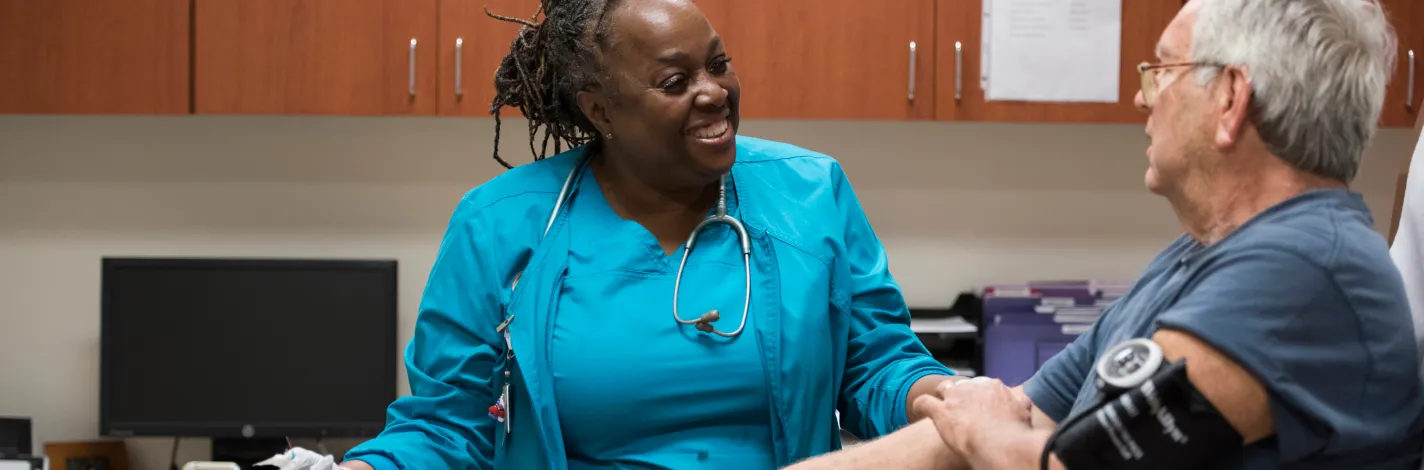 Patient and provider talking cordially in a clinical office