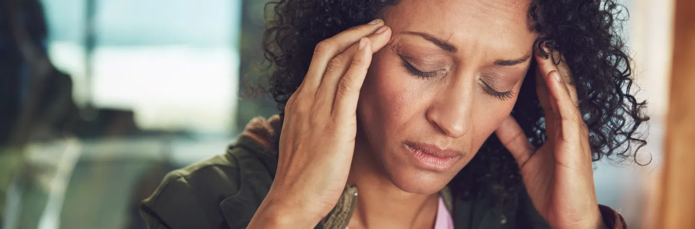 Woman holding her head in pain