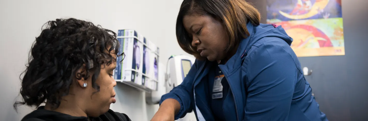 Nurse taking patient's blood pressure 