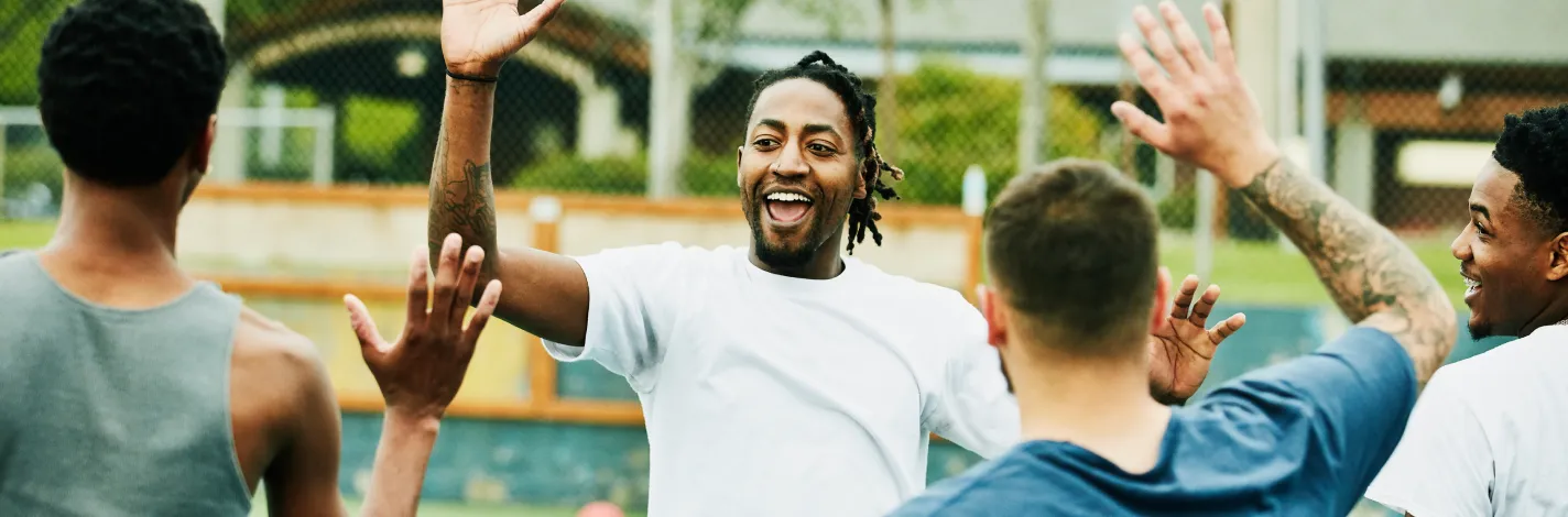 men high fiving on court