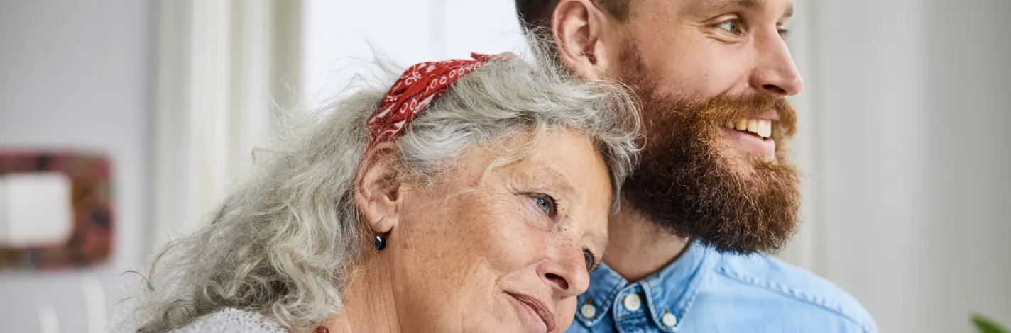 picture of adult son hugging his mother, both smiling