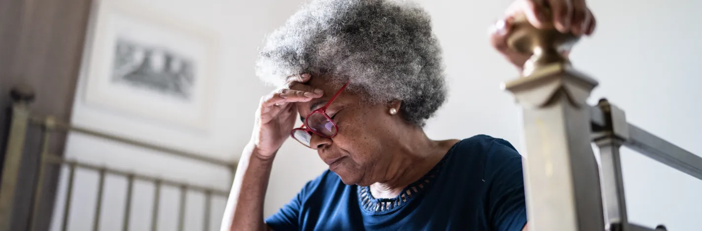 Photo of a woman with her head in her hand