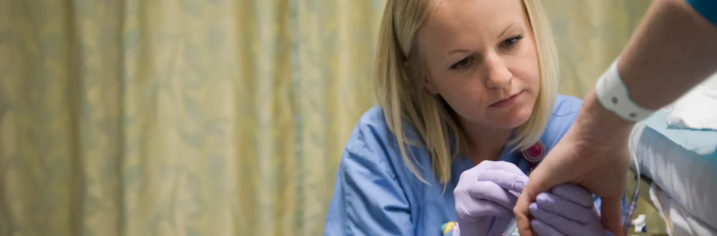 Nurse assisting a patient in bed