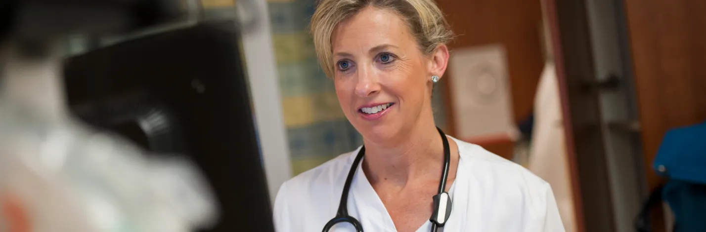 A Novant Health registered nurse (RN) is at a computer charting patient information. A Novant Health registered nurse (RN) is at a computer charting patient information.