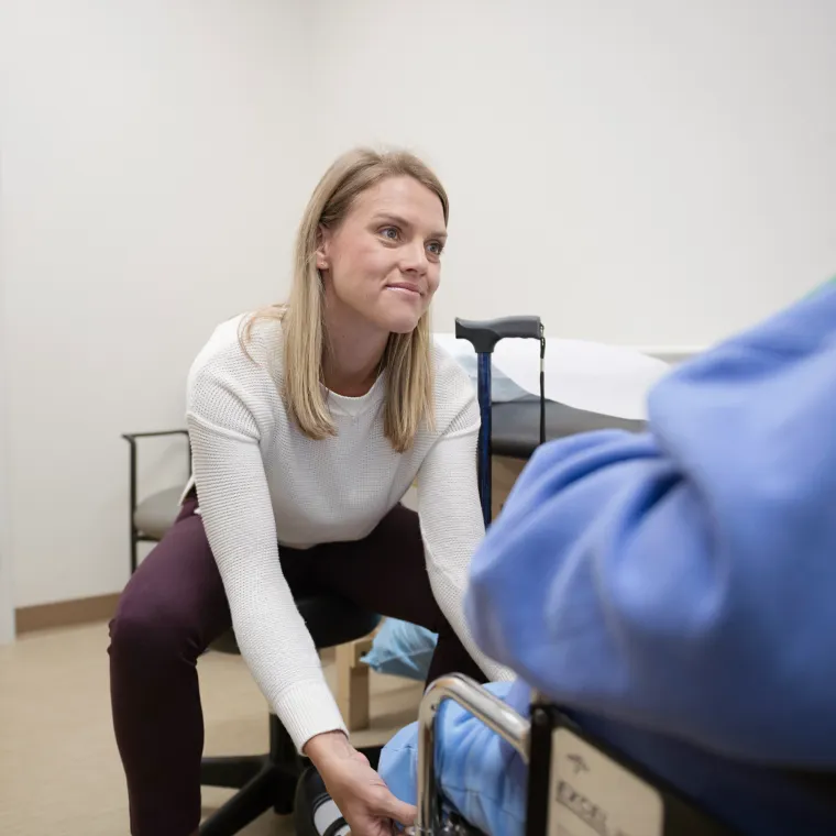 Novant Health's Doctor Harvey providing care to a patient in a wheelchair. Novant Health's Doctor Harvey providing care to a patient in a wheelchair.