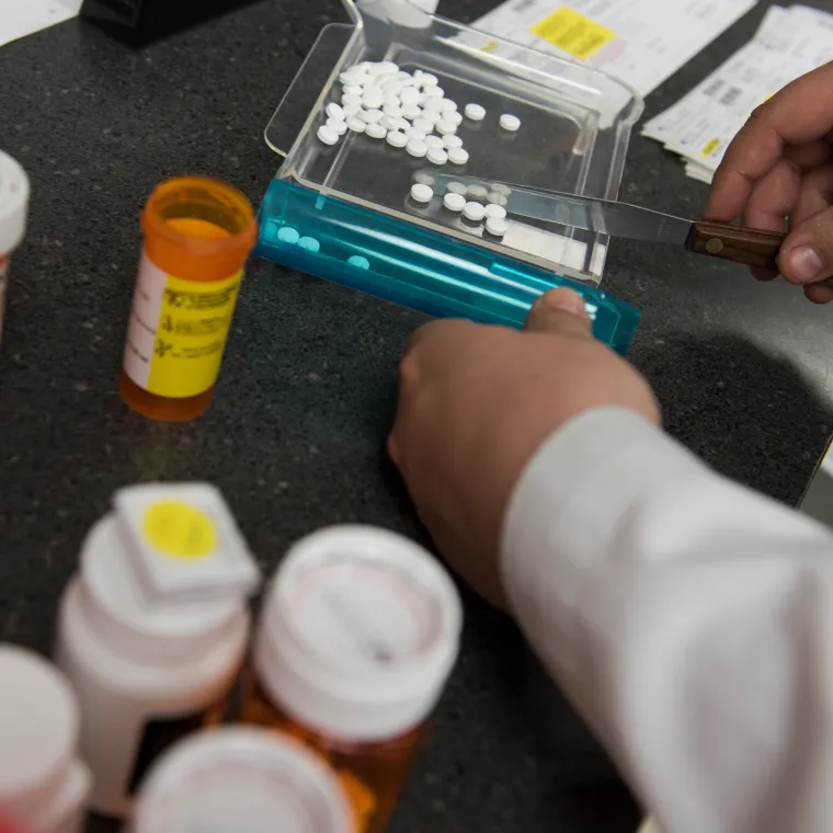 A Novant Health pharmacist is counting medication pills as they fill a patients prescription. 