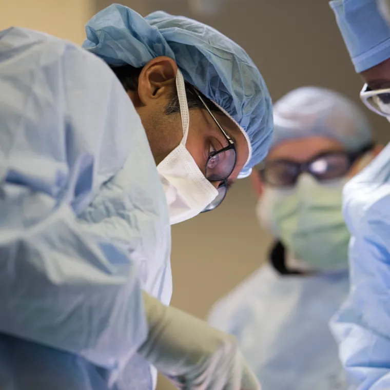 Group of healthcare providers in an operating room performing surgery. Group of healthcare providers in an operating room performing surgery.