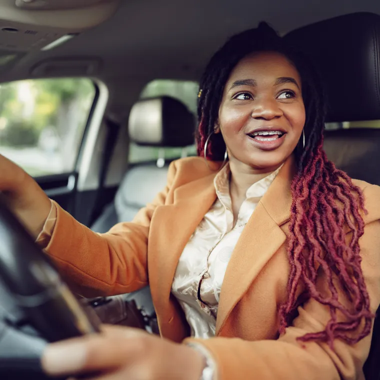 Smiling woman in her car Smiling woman in her car