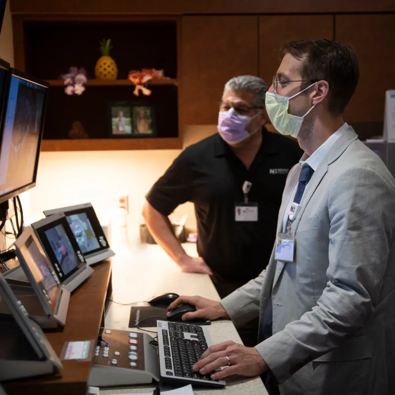 Dr. Fairchild is reviewing patient information with a team member. Dr. Fairchild is reviewing patient information with a team member.