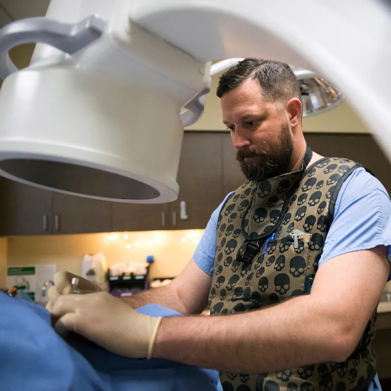 Dr. Peacock performing a procedure on patient with neurology technology. 