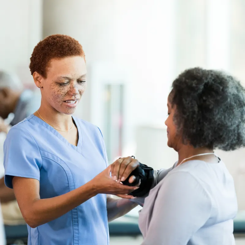 A physical therapist is examing a womans wrist